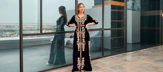 Woman wearing a black velvet Moroccan kaftan with gold embroidery and a waist belt—evening styling guide.